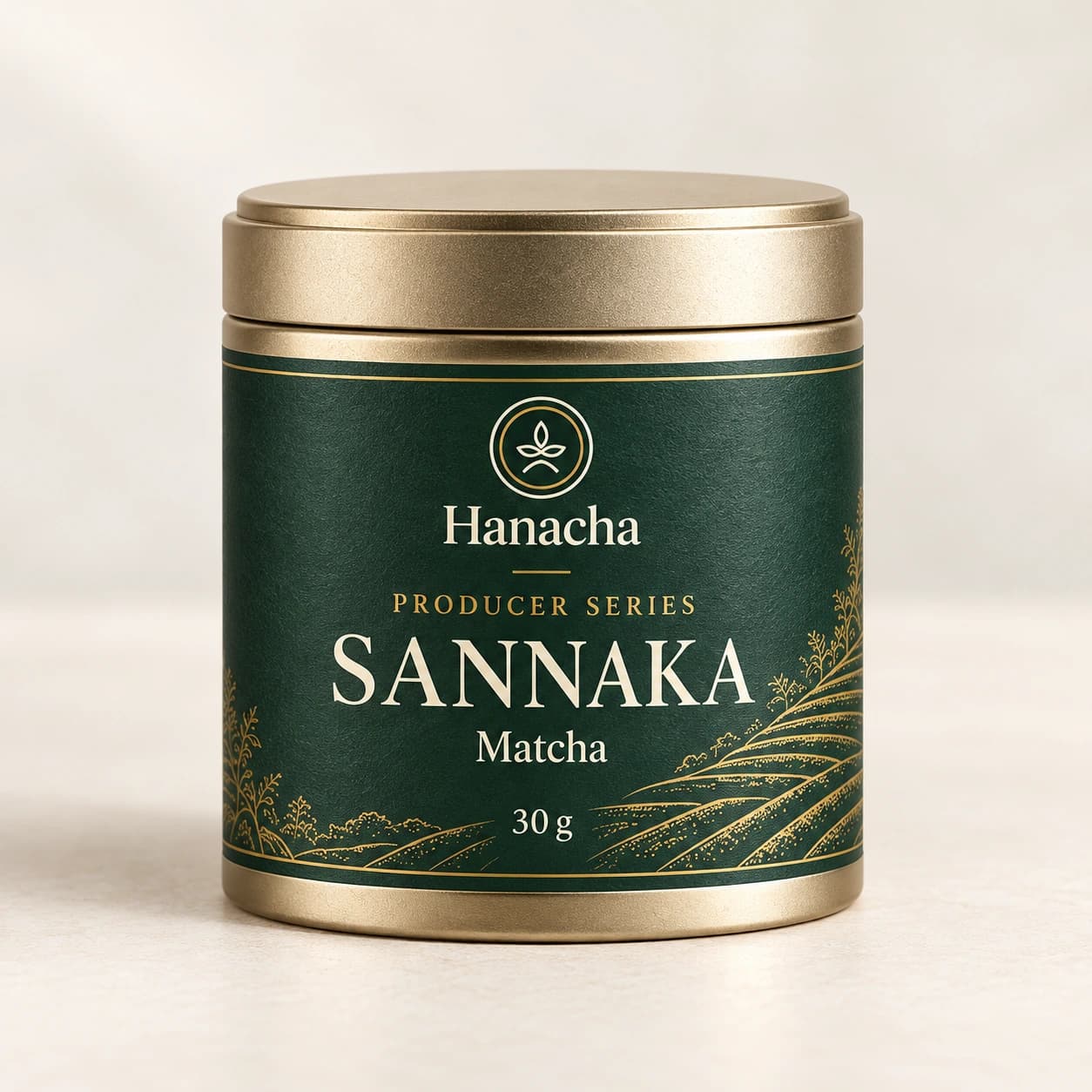 Hanacha Producer Series SANNAKA matcha in a compact champagne-gold 30 g tin with a deep green label