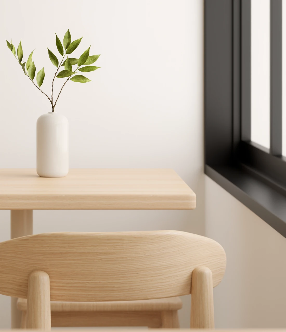 A sunlit café with timber furniture and a white vase of green branches