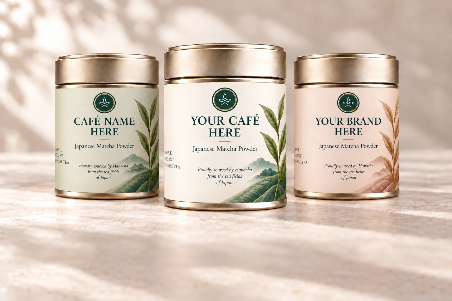 Three gold matcha tins in pastel sage, cream and blush, labelled Café Name Here, Your Café Here and Your Brand Here
